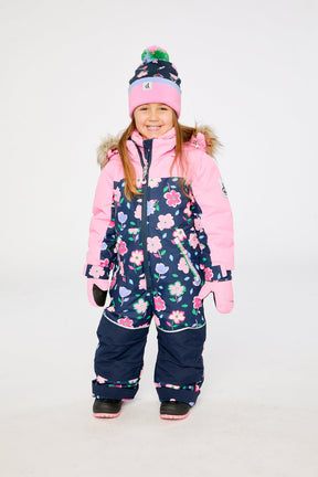 Child wearing the Deux par Deux kids DISCOVER one-piece snowsuit in Blue Floral Print in a winter lookbook view