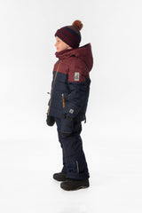 Boy in the navy and burgundy Deux par Deux PLAY snowsuit, side view