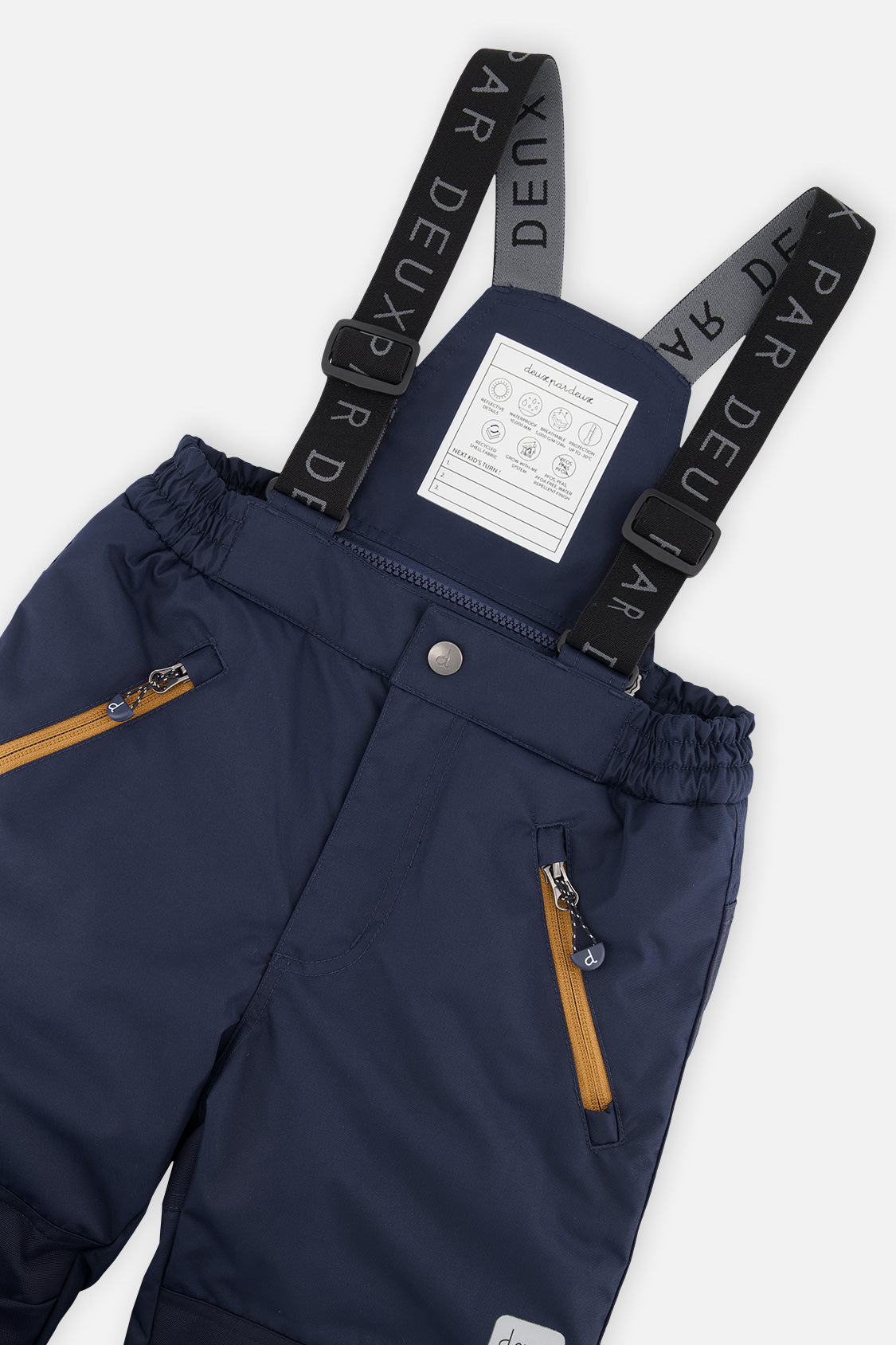 Deux par Deux boys PLAY snowsuit, navy and burgundy – close-up of the suspenders and zippered pant pockets