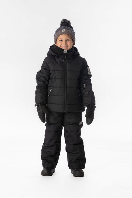 Boy standing in the all-black Deux par Deux PLAY snowsuit, full-length front view