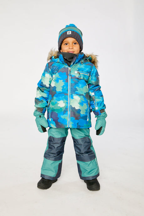 Boy wearing Deux par Deux blue camouflage PLAY snowsuit with green snow pants