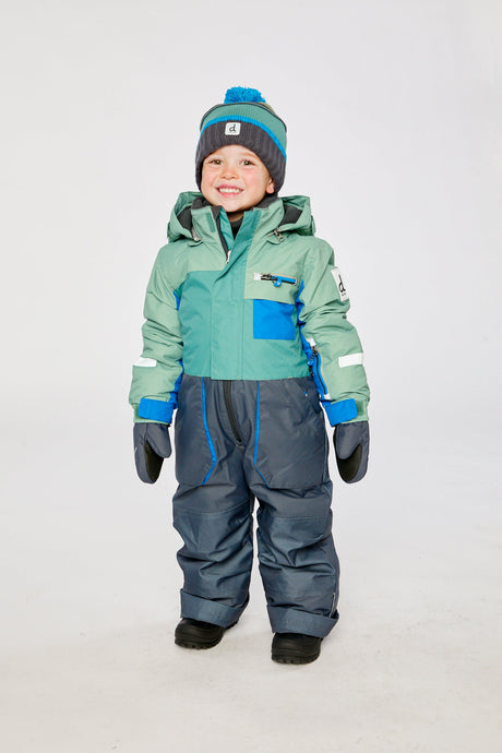 Child wearing the sage green and grey Deux par Deux PLAY one-piece snowsuit in a winter lookbook view