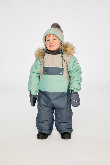 Baby wearing the Deux par Deux baby car-seat one-piece snowsuit in Cool Dark Grey in a winter lookbook view