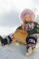 Deux par Deux girls purple floral one-piece snowsuit with articulated fit for active winter play.