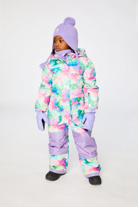 Child wearing the Deux par Deux multicolor diamond-print PLAY one-piece snowsuit in a winter lookbook view
