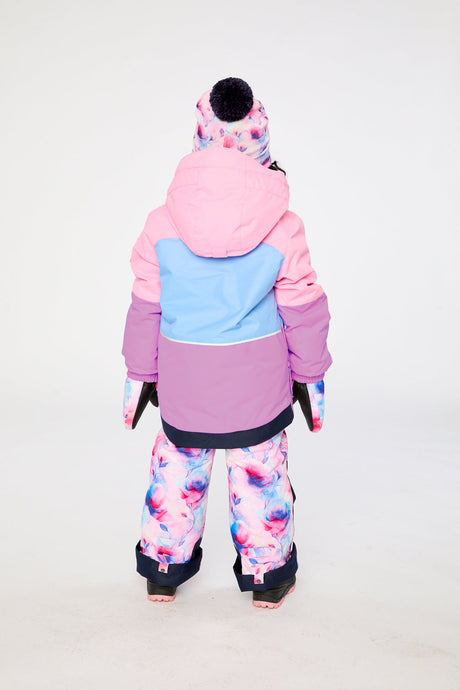 Girl in Deux par Deux PLAY snowsuit with pink purple jacket and floral reinforced snow pants