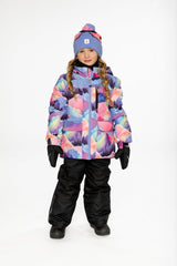 Front view of a child wearing the Deux par Deux pink mountain-print snowsuit with black snow pants