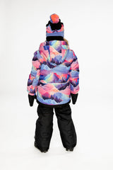 Back view of a child wearing the pink mountain-print hooded jacket and black snow pants