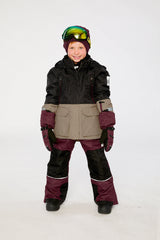 Child wearing the black, beige and burgundy Deux par Deux TEKNIK snowsuit in a winter lookbook view