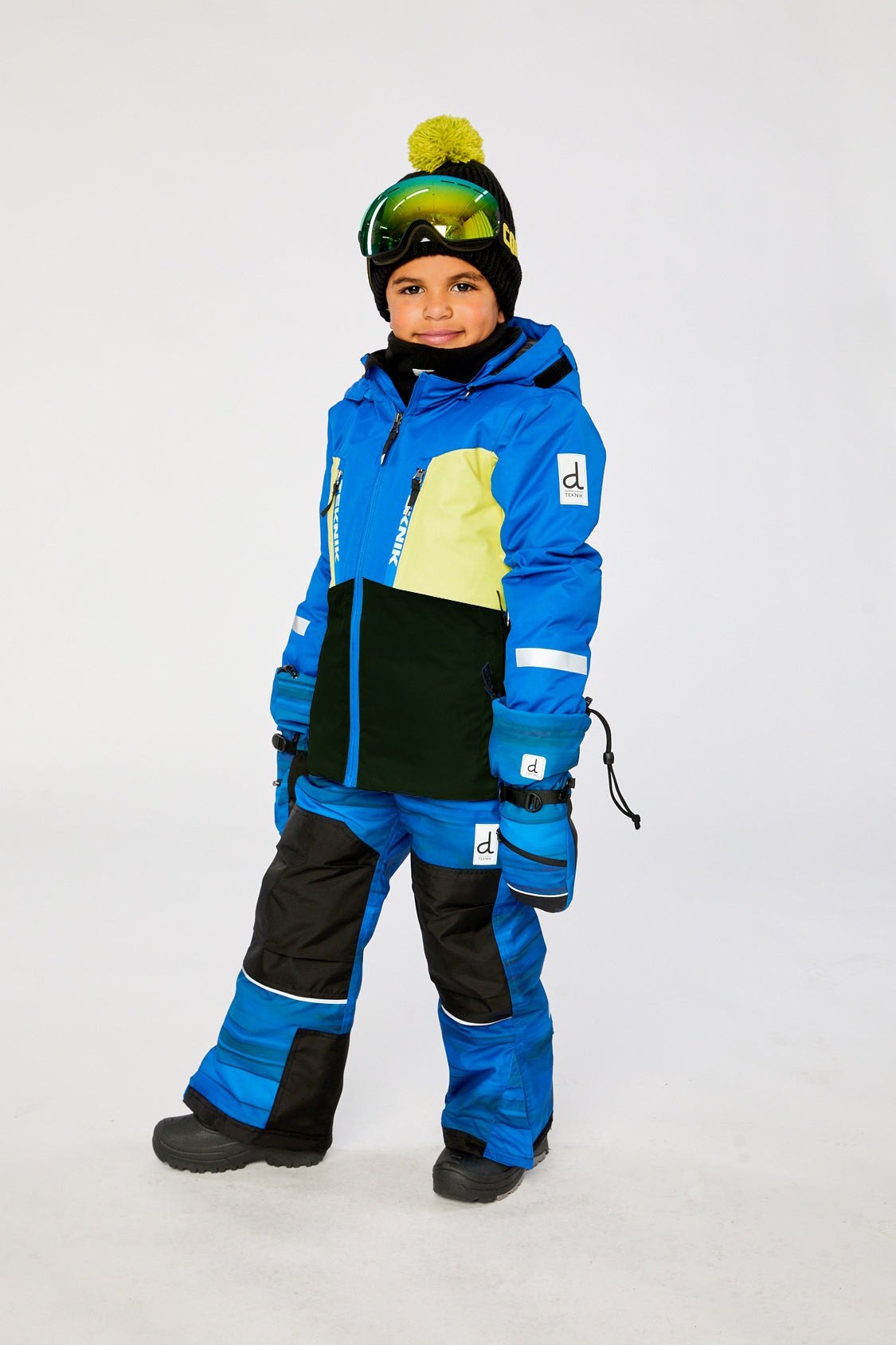 Deux par Deux TEKNIK two-piece snowsuit in Royal Blue and Yellow shown from an alternate modeled winter angle