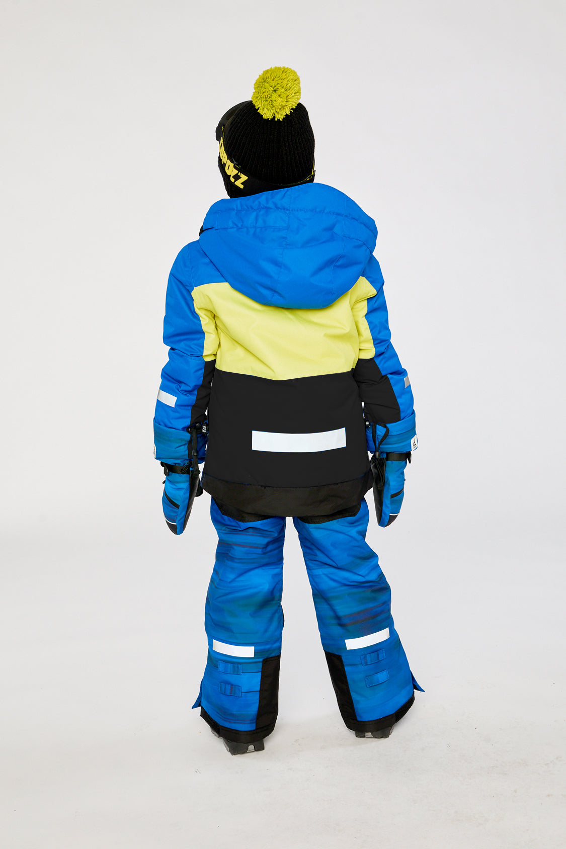 Alternate winter lookbook view of the Deux par Deux TEKNIK two-piece snowsuit in Royal Blue and Yellow