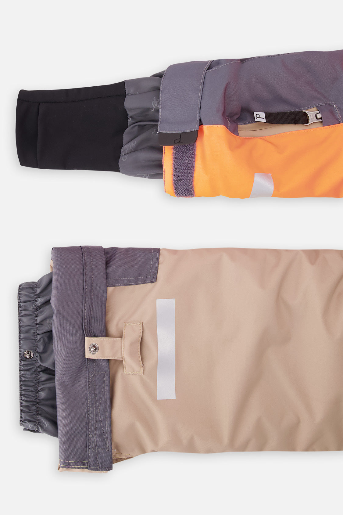 Close-up of the TEKNIK jacket cuff and the adjustable snow pant hem with snap tab