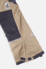 Close-up of the taupe and grey snow pants leg with reinforced panels and inner snow gaiter