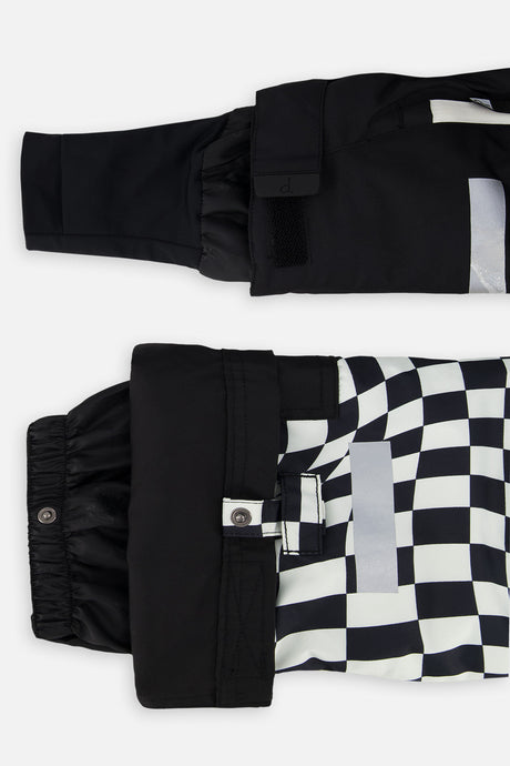 Close-up of the TEKNIK jacket cuff and the adjustable snow pant hem with snap tab