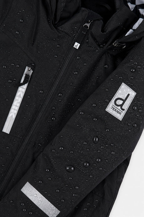 Water beading on the black TEKNIK jacket shell beside the logo patch