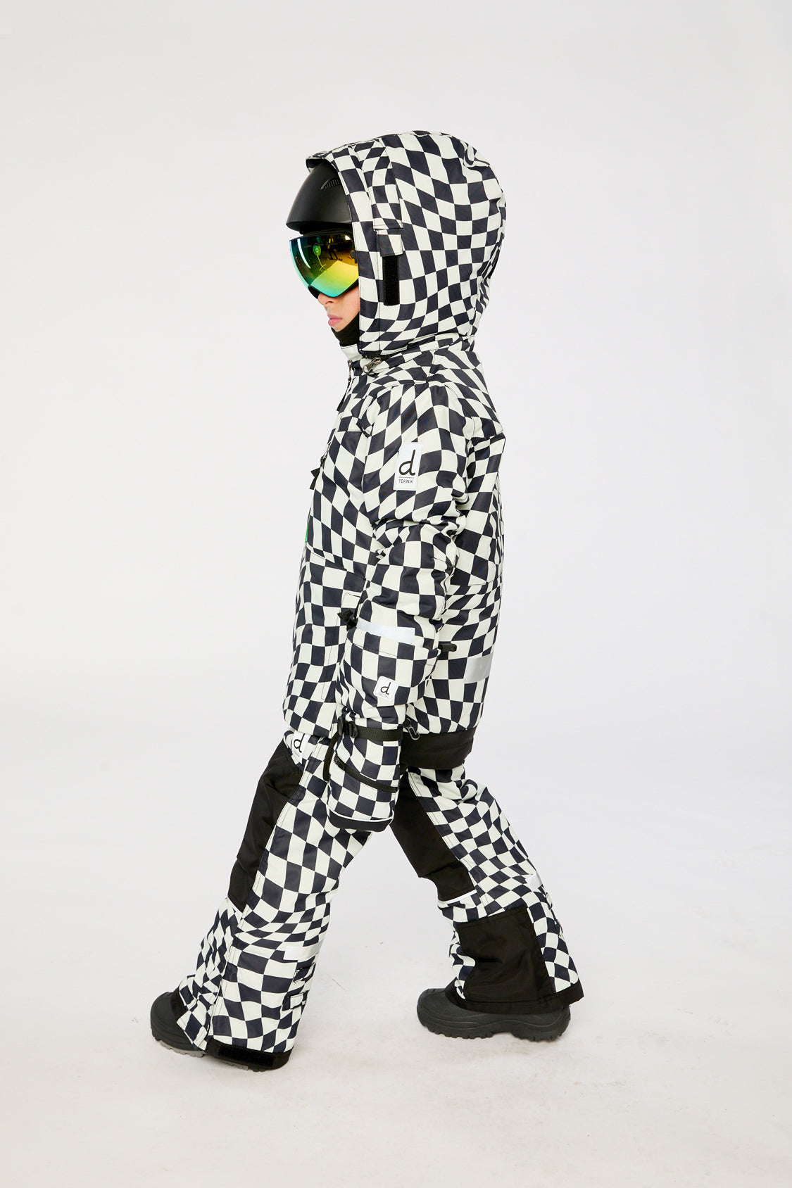 Deux par Deux TEKNIK two-piece snowsuit in White Checkered Print shown from an alternate modeled winter angle