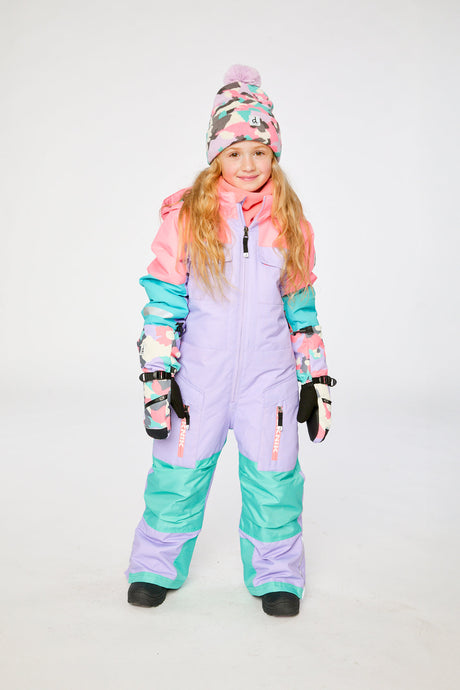 Child wearing the lavender turquoise orange Deux par Deux TEKNIK snowsuit in a winter lookbook view