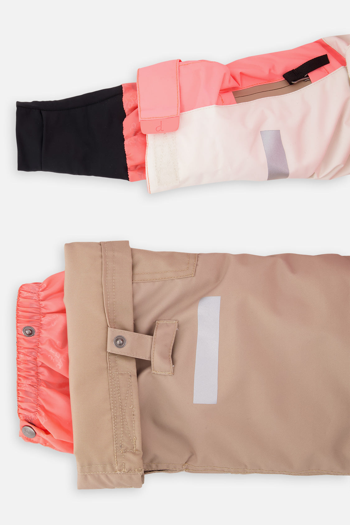 Close-up of the TEKNIK jacket cuff and the adjustable snow pant hem with snap tab