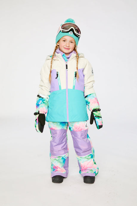 Child wearing the Deux par Deux TEKNIK two-piece snowsuit in Multicolored with A Diamond Pattern in a winter lookbook view