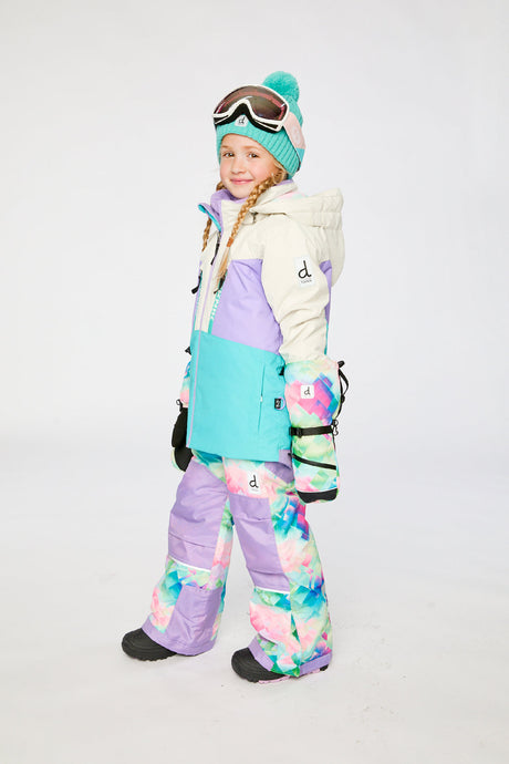 Deux par Deux TEKNIK two-piece snowsuit in Multicolored with A Diamond Pattern shown from an alternate modeled winter angle
