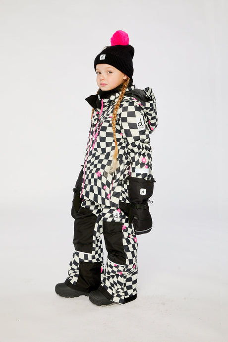Deux par Deux TEKNIK two-piece snowsuit in White and Bright Pink Checkered Print shown from an alternate modeled winter angle
