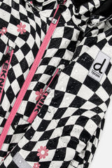 Water beading on the checkered TEKNIK jacket shell beside the logo patch