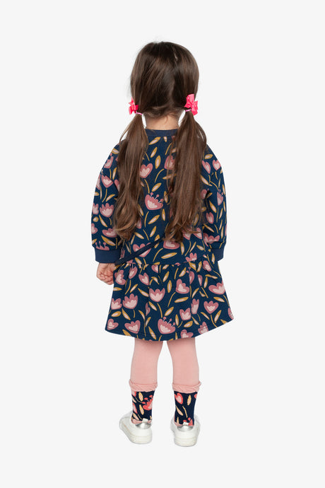 Child wearing the long-sleeve blue tulip print dress, lookbook photo