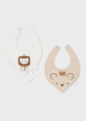 Two tan and white baby bibs with lion and animal-face designs