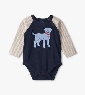 Front of Hatley Blue Pup navy baby bodysuit with a light blue dog, striped raglan sleeves and red-trimmed snaps.