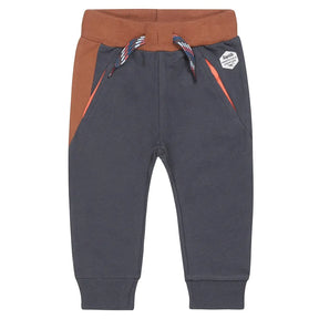 Front view of dark-blue Dirkje boys joggers with brown waistband and orange pocket trim