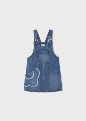Front view of blue denim girls overall skirt with adjustable straps