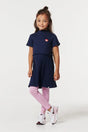 Girl wearing Noppies Gondiya navy ribbed dress with pink leggings, front view