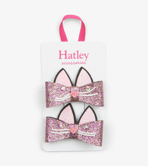 Two Hatley glitter cat bow hair clips with pink ears, gem eyes, heart noses and white whiskers on a display card.