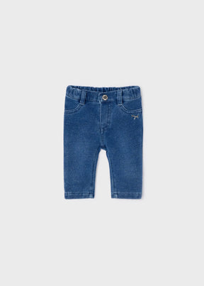 Front view of blue newborn denim jeggings with snap button and pockets