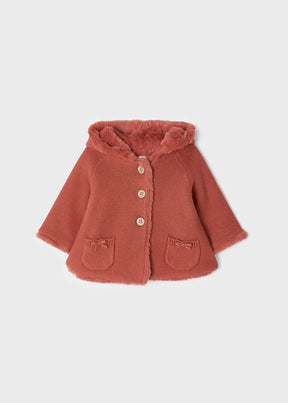 Front view of rust baby knit cardigan with faux-fur trim and pockets
