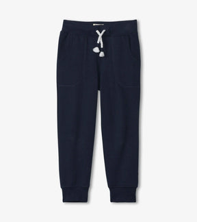 Hatley boys navy slim-fit joggers with white drawcord, angled pockets and cuffed ankles, front view