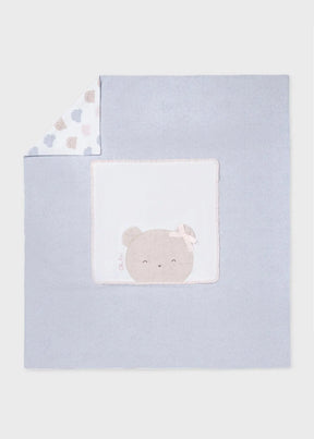 Pale blue baby blanket with white panel and sleepy bear appliqué