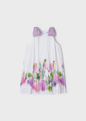 White pleated girls dress with lilac shoulder bows and floral hem