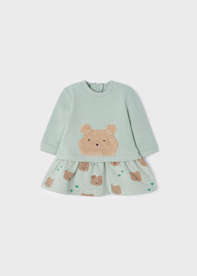 Front view of mint baby dress with bear appliqué and printed skirt