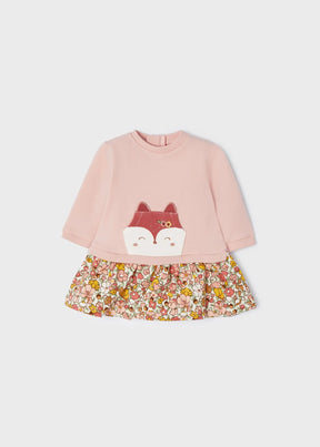 Front view of pink baby dress with fox pocket and floral skirt