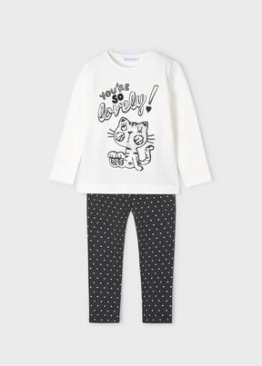 Front view of ivory graphic top and charcoal polka dot leggings set