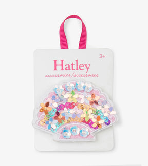Hatley pink seashell hair clip with multicolor floral sequins on branded display card