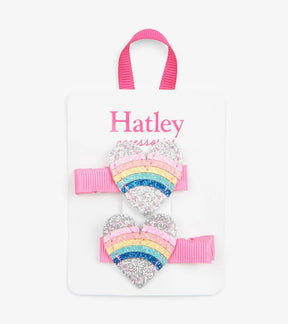 Two Hatley silver glitter heart hair clips with rainbow stripes, pink stitching and pink ribbon-covered clips.