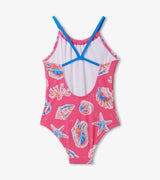 Back view of Hatley seashell print girls swimsuit with blue cross straps