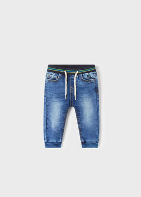 Medium blue baby boy denim joggers with striped drawstring waist, front view