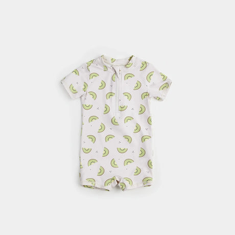 Kiwi print baby boy swim romper in crème and green on neutral background.
