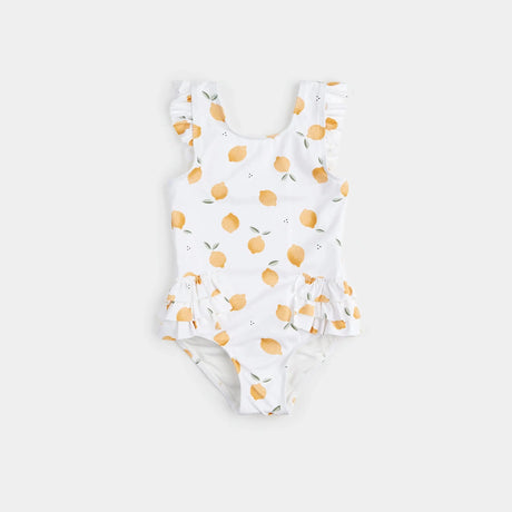 Off-white lemon-print one-piece swimsuit with frilly straps laid flat on neutral background.