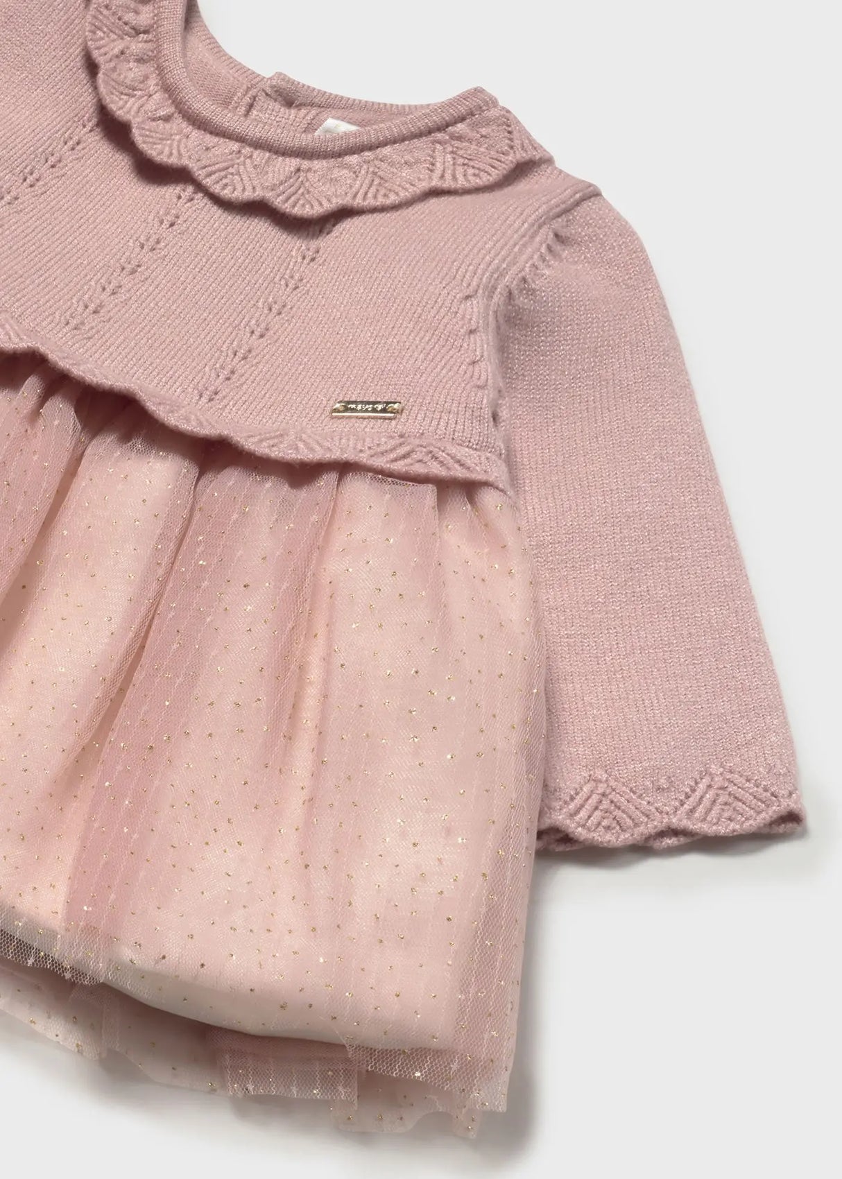Lifestyle photo showing side angle of Mayoral newborn dress
