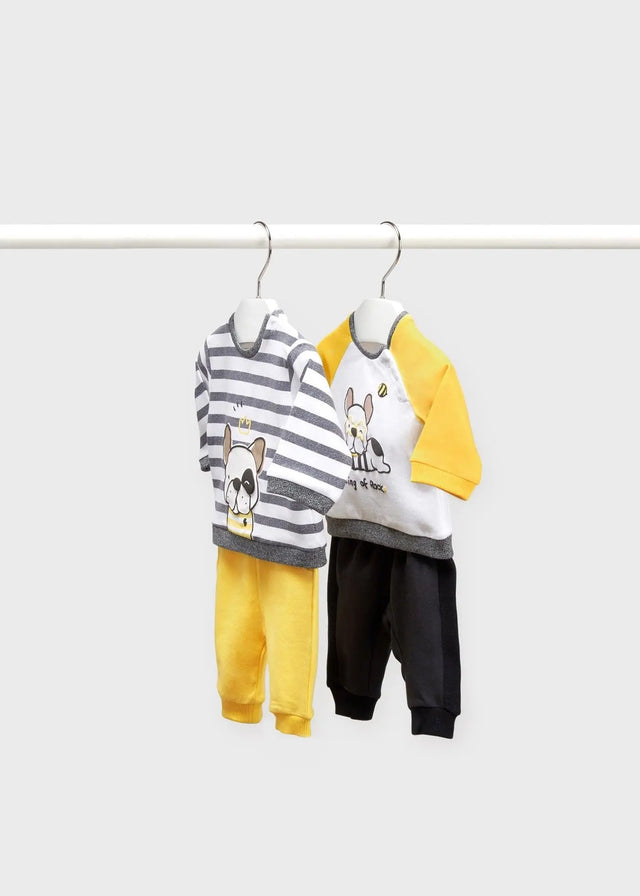 Flat lay of Mayoral newborn boy baby outfit set with two tees and two joggers in Yellow/Black/Grey.