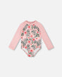 Front flat lay of Deux par Deux girl long sleeve one-piece rashguard in pink hibiscus print